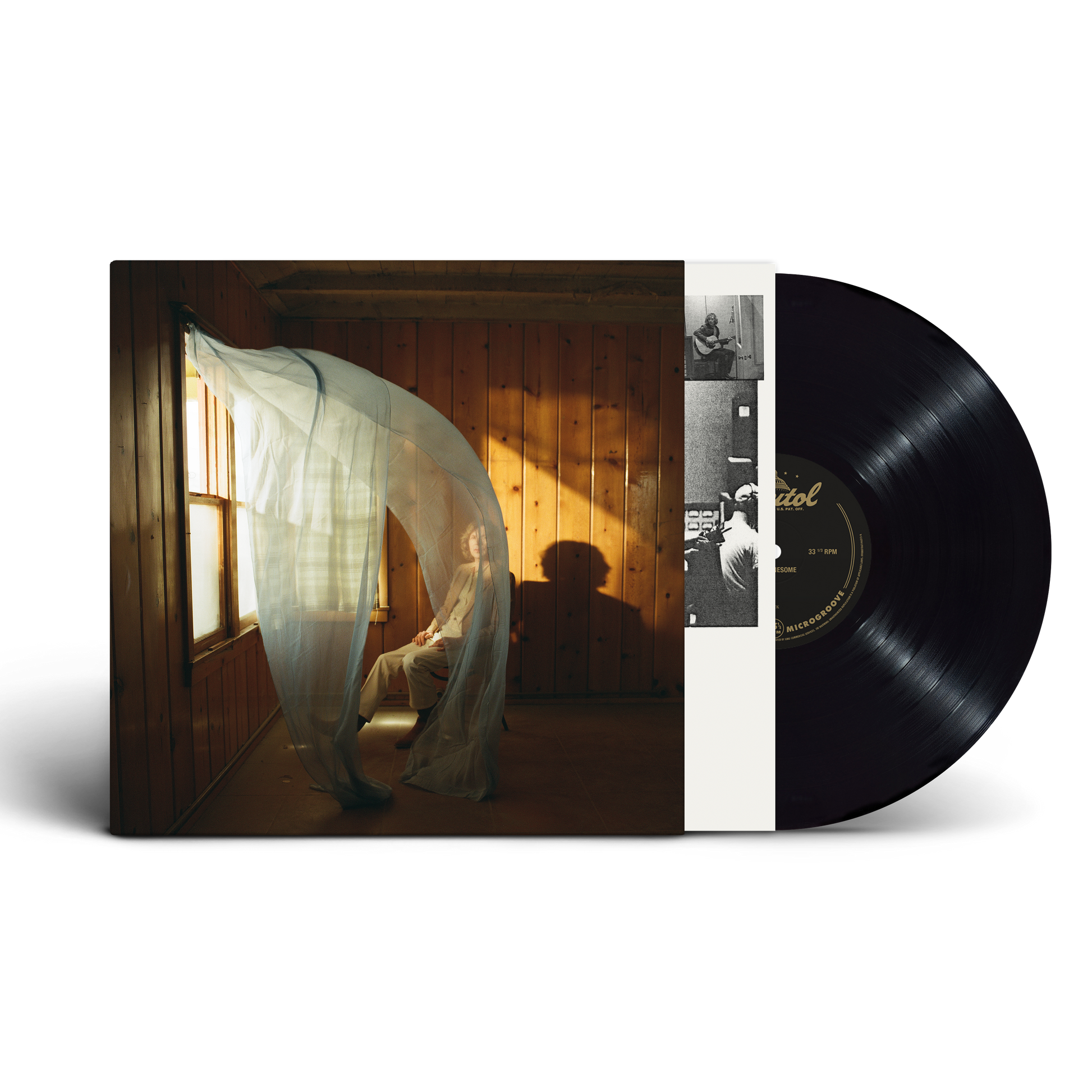A vinyl record partially pulled from its album sleeve, showing the cover art of Beck in a room with warm sunlight and a black LP disc on a white background.